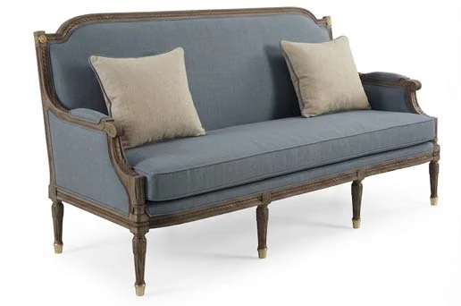 Classic sofa upholstered in blue fabric with cushions